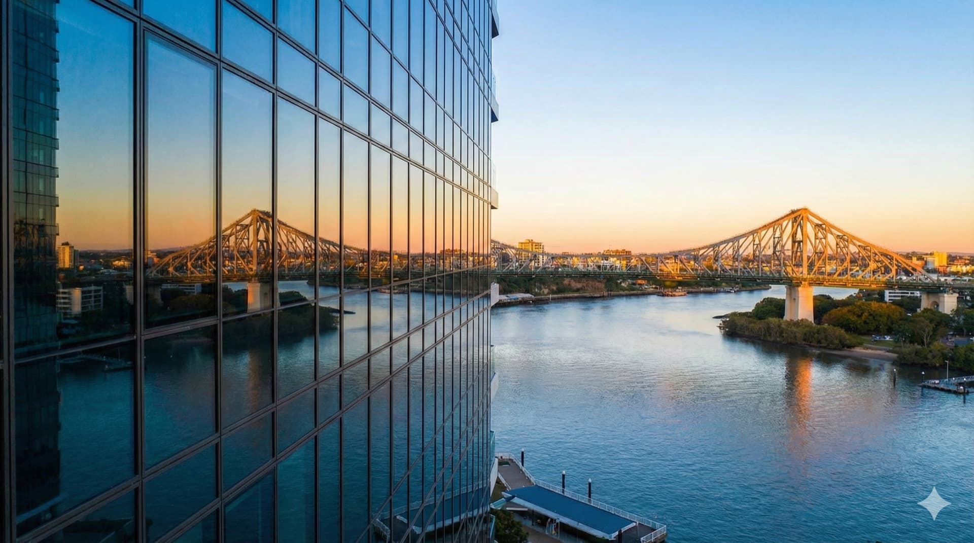 Bridge and river reflected in glass tower